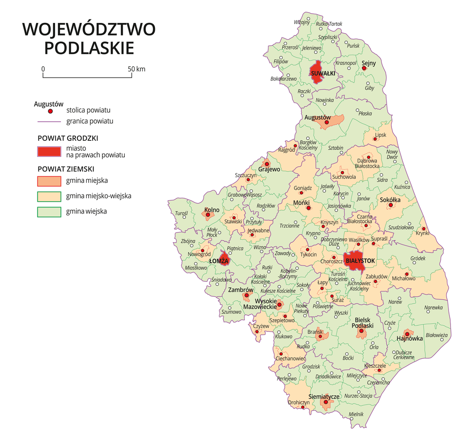 Mapa województwa podlaskiego. Na mapie fioletowymi liniami zaznaczono granice powiatów ziemskich, dużymi czerwonymi kropkami zaznaczono miasta będące stolicami powiatów. W obrębie powiatów ziemskich kolorami wyróżniono gminy miejskie, miejsko-wiejskie i wiejskie. Czerwonym kolorem wyróżniono powiaty grodzkie z miastami na prawach powiatu, miasta te opisano dużymi literami. Kolory i znaki użyte na mapie opisano w legendzie. W legendzie podziałka liniowa.
