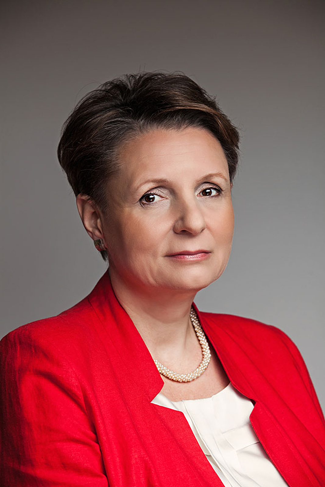 Kolorowe zdjęcie portretowe Małgorzaty Omilanowskiej. Kobieta w wieku około 55 lat. Twarz okrągła. Gładka. Włosy ciemne, proste, krótkie. Zaczesane do tyłu z przedziałkiem na środku. Brwi wąskie, jasno brązowe. Oczy małe. Nos duży. Usta wąskie. Uszy małe, przylegające. Ubrana w czerwoną bluzkę z kołnierzykiem.