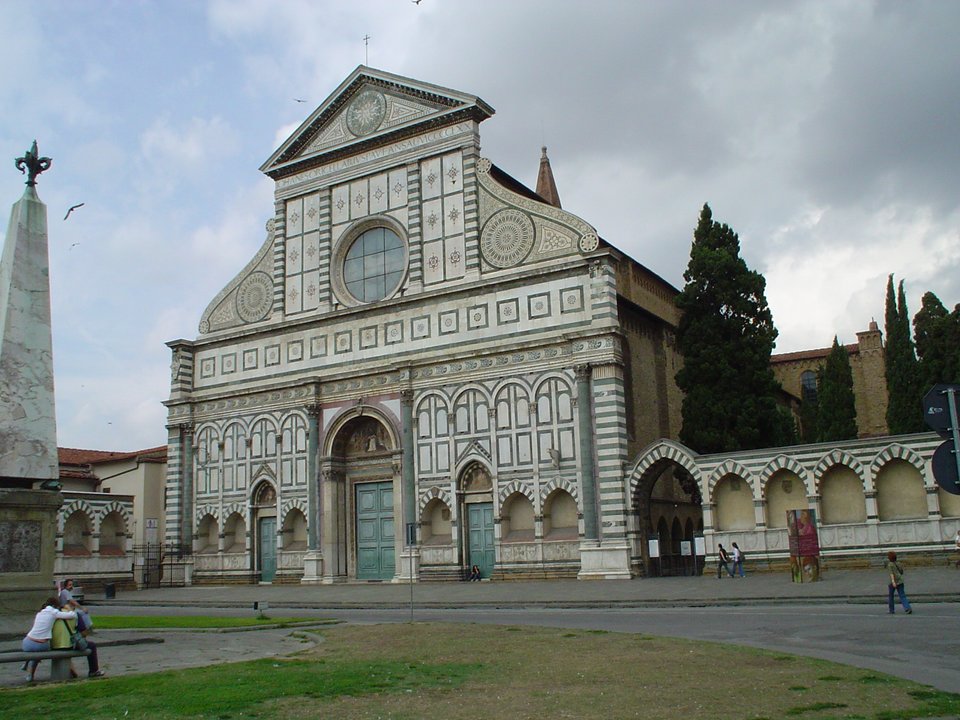 Fasada kościoła Santa Maria Novella we Florencji. Fasada średniowiecznego kościoła przyklasztornego dominikanów zaprojektowana została przez znanego teoretyka architektury renesansowej L.B. Albertiego i wykonana w latach 1456-1470. Zwróć uwagę na połączenie elementów gotyckich w postaci kilku zwieńczeń ostrołukowych z dominującymi łukami półkolistymi nawiązującymi do tradycji rzymskich łuków triumfalnych. Ważnym elementem było zastosowanie spływów wolutowych - wykończeń dachu w kształcie ślimacznicy stanowiących zamknięcie połaci dachowej między wyższą nawą główną a niższymi nawami bocznymi. Stanie się to stałym elementem późniejszych fasad renesansowych, a przede wszystkim barokowych. Fasada kościoła Santa Maria Novella we Florencji. Fasada średniowiecznego kościoła przyklasztornego dominikanów zaprojektowana została przez znanego teoretyka architektury renesansowej L.B. Albertiego i wykonana w latach 1456-1470. Zwróć uwagę na połączenie elementów gotyckich w postaci kilku zwieńczeń ostrołukowych z dominującymi łukami półkolistymi nawiązującymi do tradycji rzymskich łuków triumfalnych. Ważnym elementem było zastosowanie spływów wolutowych - wykończeń dachu w kształcie ślimacznicy stanowiących zamknięcie połaci dachowej między wyższą nawą główną a niższymi nawami bocznymi. Stanie się to stałym elementem późniejszych fasad renesansowych, a przede wszystkim barokowych. Źródło: Maksim, Wikimedia Commons, licencja: CC BY-SA 3.0.