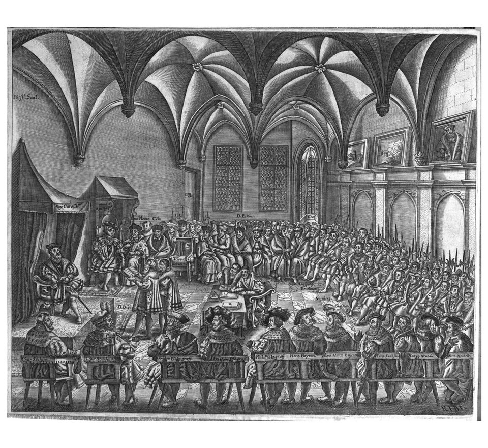 Sztych przedstawia moment prezentacji tzw. „Konfesji Augsburskiej” na sejmie Rzeszy w 1530 r. Przed władcami zasiadającymi na tronach: cesarzem Karolem V i jego bratem królem Czech i Węgier Ferdynandem stoi czytający postanowienia „Konfesji” kanclerz Christian von Beyer. Dookoła siedzą członkowie sejmu, czyli władcy Rzeszy. Sztych przedstawia moment prezentacji tzw. „Konfesji Augsburskiej” na sejmie Rzeszy w 1530 r. Przed władcami zasiadającymi na tronach: cesarzem Karolem V i jego bratem królem Czech i Węgier Ferdynandem stoi czytający postanowienia „Konfesji” kanclerz Christian von Beyer. Dookoła siedzą członkowie sejmu, czyli władcy Rzeszy. Źródło: domena publiczna.