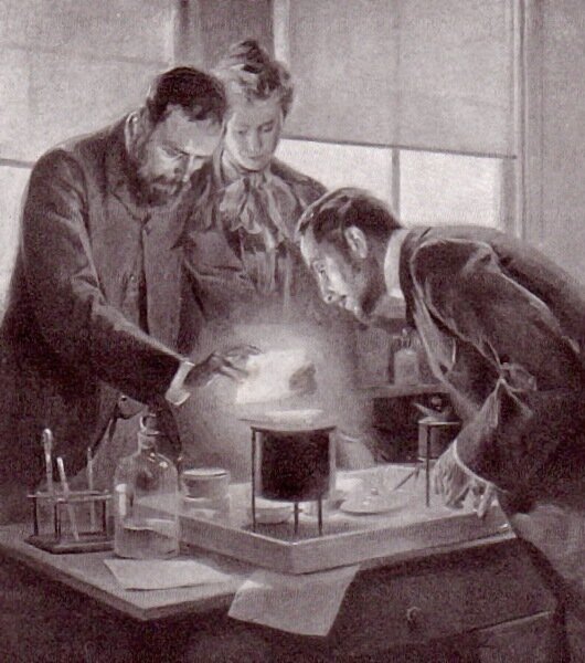 Pan i Pani Curie eksperymentują z radem Źródło: André Castaigne, Pan i Pani Curie eksperymentują z radem, 1903, domena publiczna.